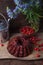 Delicious chocolate cake with sweet cherry, vintage kettle and bouquet of blue flowers on dark wooden background