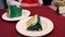 Delicious chocolate cake in white plate on wooden table background, closeup. Tasty chocolate cake with berries on table