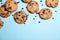 Delicious chocolate chip cookies on color background