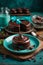 Delicious chocolate dessert on turquoise tableware on a wooden table