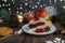 Delicious Christmas raspberry pie with berry filling and icing sugar and spices on a dark background.