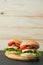 Delicious classic burgers on wooden serving board.