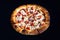 Delicious classic italian Pizza Pepperoni with sausages and cheese mozzarella. black dark background