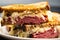 Delicious close-up of a classic Reuben sandwich with corned beef, sauerkraut, Swiss cheese,
