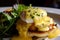 delicious close-up of Eggs Benedict with juicy crab cakes, tangy remoulade sauce, and perfectly poached eggs on a bed of buttery