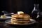 Delicious close up shot of spongy pancakes with maple syrup and butter over dark background.