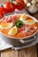 Delicious cold Antequera Porra soup of fresh vegetables with boiled eggs and serrano ham close-up. vertical