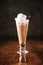 Delicious cold chocolate ice cream milkshake with cookie in a long glass