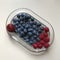 A delicious collection of berries sit on a glass dish - Strawberries & raspberries - FRUIT