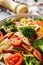 delicious colored farfalle pasta on a stone background