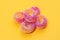 Delicious and colorful jelly rings on yellow background