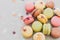 Delicious colorful macaroons on trendy pastel gray paper with li