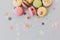 Delicious colorful macaroons on trendy pastel gray paper with li