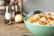 Delicious cooked dumplings with onion on wooden table, closeup. Space for text