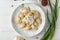 Delicious cooked dumplings with sour  on white wooden table, flat lay