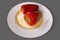 Delicious cooked red bell pepper stuffed with meat and rice served on white dish with yummy gravy and paprika spic