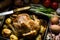 Delicious country style roasted chicken with apples potatoes in baking form on kitchen table, Eas