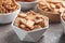 Delicious crackers in bowls on grey table, closeup