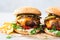 Delicious craft cheeseburgers with roasted pepper, cheddar cheese and dill pickles