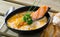 Delicious cream soup with salmon, served in bowl with bread at table