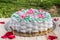 Delicious creamy cake basket of roses on wooden table