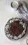 Delicious creamy cheesecake decorated with chocolate glaze and almond, light concrete background. No bake mousse dessert