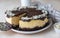 Delicious creamy cheesecake decorated with chocolate glaze and almond, light concrete background. No bake mousse dessert