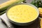 Delicious creamy corn soup on grey table, closeup