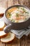 Delicious creamy fish soup with cod and salmon close-up in a bowl served with fresh bread. vertical