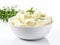 Delicious creamy mashed potatoes with butter and fresh herbs on white background. Close up of mashed potatoes on white.