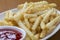 Delicious crinkle cut style french fries with ketchup