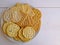 Delicious crisp salty crackers on plate on white background.