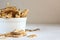 Delicious crispy coconut chips with salted caramel in a white plate on a white background. Natural product made from coconut pulp