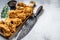 Delicious crispy fried breaded chicken parts. White background. Top view. Copy space