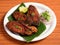 Delicious crispy King fish fry also known as indian surmai, served with onion and lemon placed over a rustic wooden background,