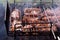 Delicious crispy meat barbecue on metal grill in open air. Cooking meat on grill in nature in summer on picnic.