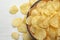 Delicious crispy potato chips in bowl on table, space for text