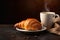 Delicious croissant and cup of coffee or tea on wooden table
