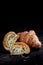 Delicious croissant, halved, look at the texture, buttery fresh on dark background