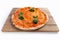 Delicious crusty cheese pizza with basil on a wooden board on a white background