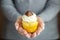 Delicious cupcake with a delicate cream and candy in the hands. Copy space. Concept for food, desserts, bakery, celebration,