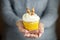 Delicious cupcake with a delicate cream in hand. Copy space. Concept for food, desserts, bakery, celebration, birthday