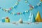 Delicious cupcake, party hats, confetti and gifts on blue background