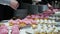 Delicious cupcakes on candy buffet, people takes food from smorgasbord