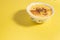 Delicious custard in a bowl on yellow background