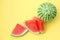 Delicious cut and whole ripe watermelons on yellow background, flat lay. Space for text