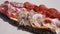 Delicious cutting board of fresh cold cuts on wooden plate. Bacon, coppa, salami and bresaola. Traditional Italian mountain dish