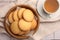 Delicious Danish butter cookies and tea on white tiled table, flat lay