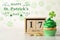 Delicious decorated cupcake, block calendar and coins on light table. St. Patrick`s Day celebration