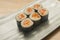 Delicious and delicate dish of Japanese sushi rolls on beautiful slate set up in traditional healthy Asian food and creative